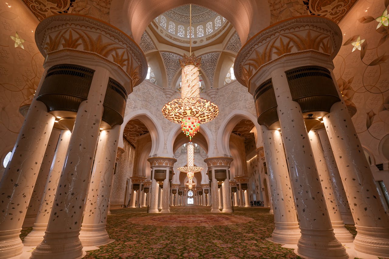 Stunning interior view of Sheikh Zayed Grand Mosque showcasing ornate columns and chandeliers.